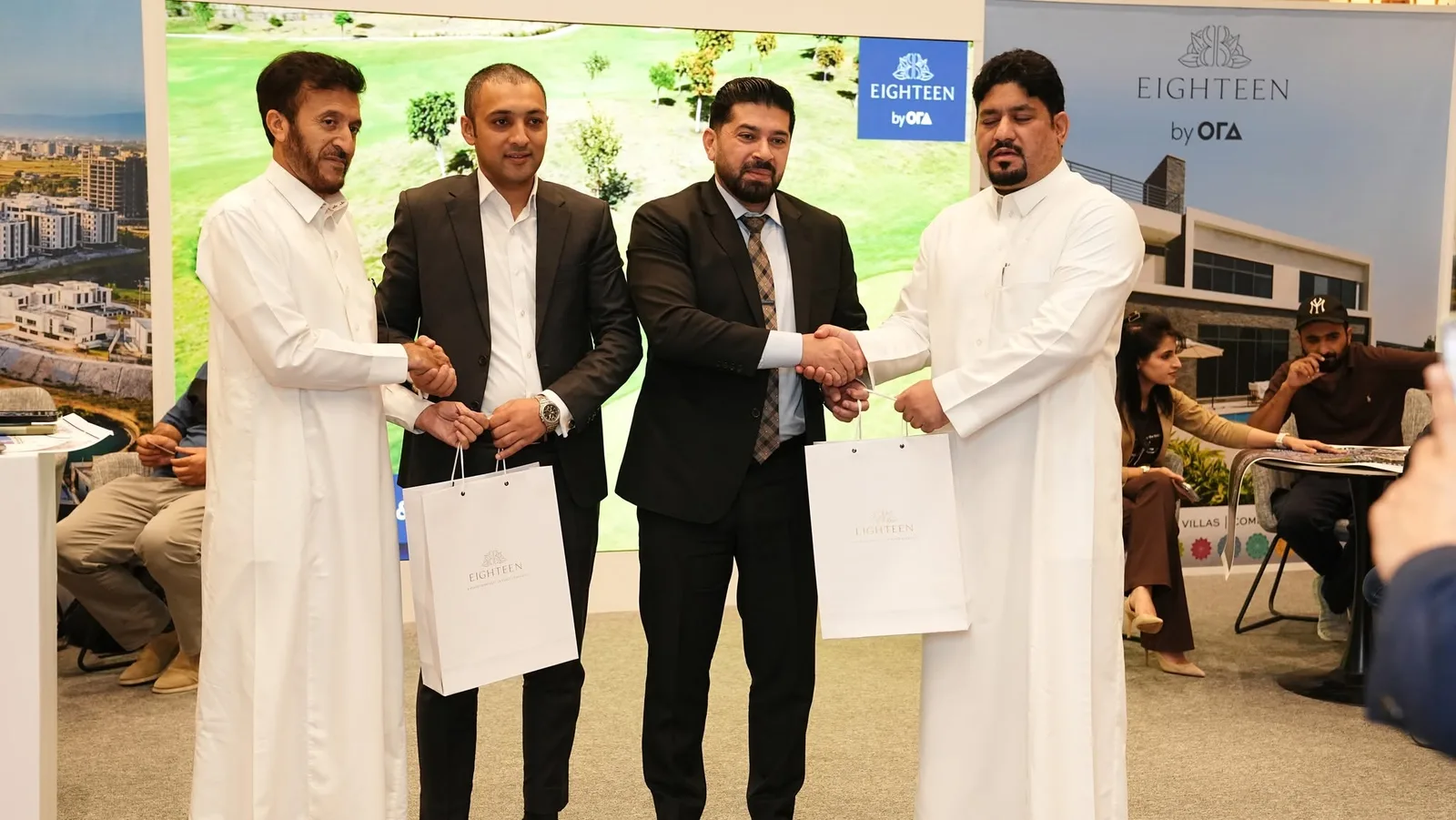 Exchanging tokens of appreciation with real estate developers at the exhibition