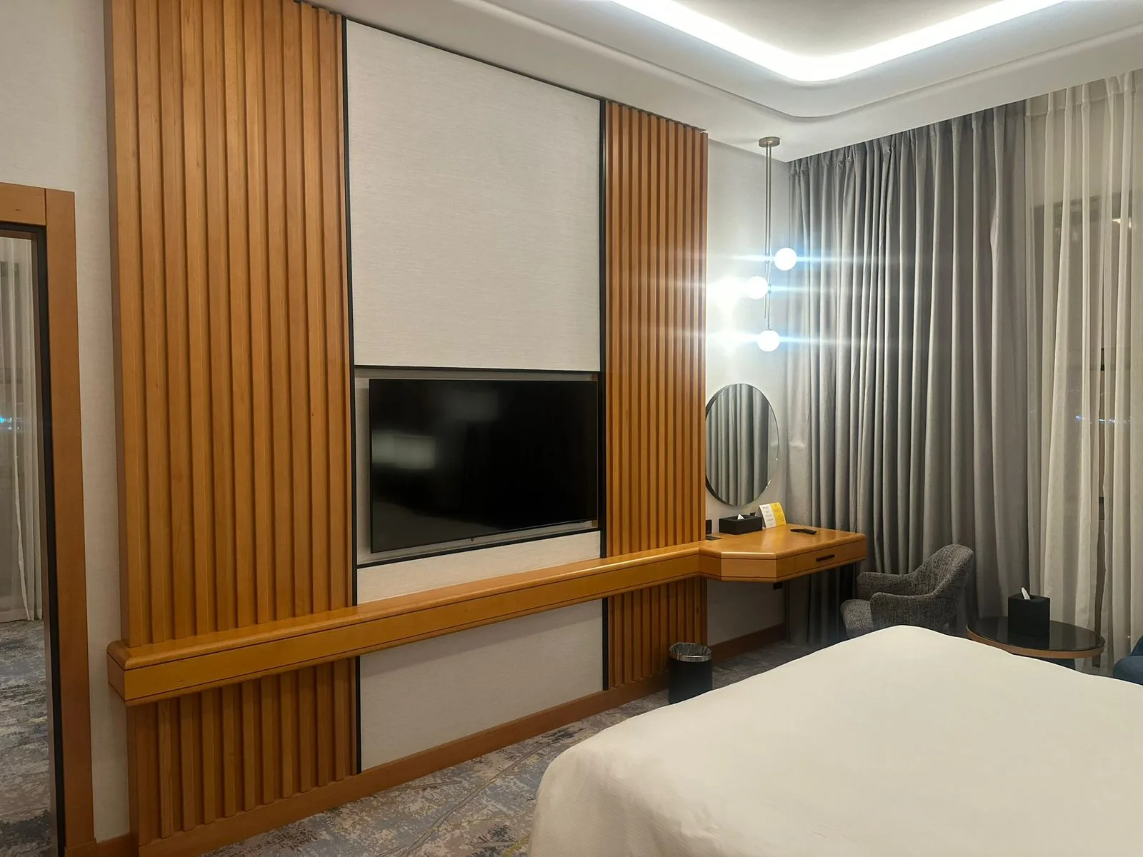 Guest room with warm timber panelling and integrated joinery