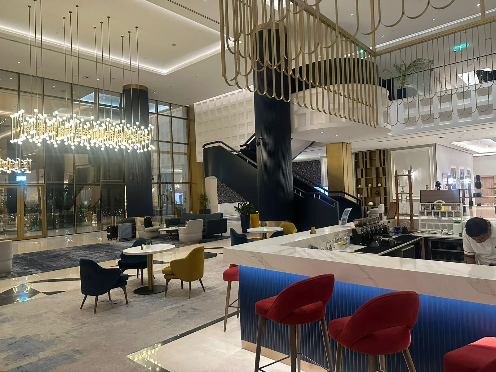 Lobby lounge and bar area with marble counters and bespoke seating