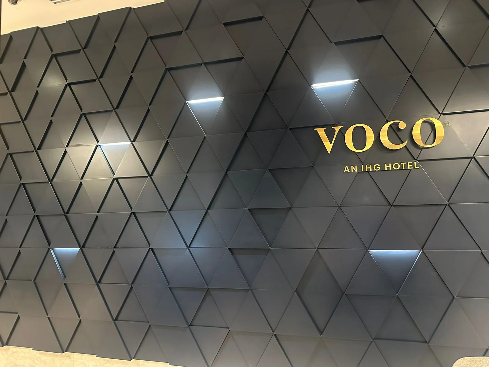 voco brand feature wall with sculpted triangular panelling